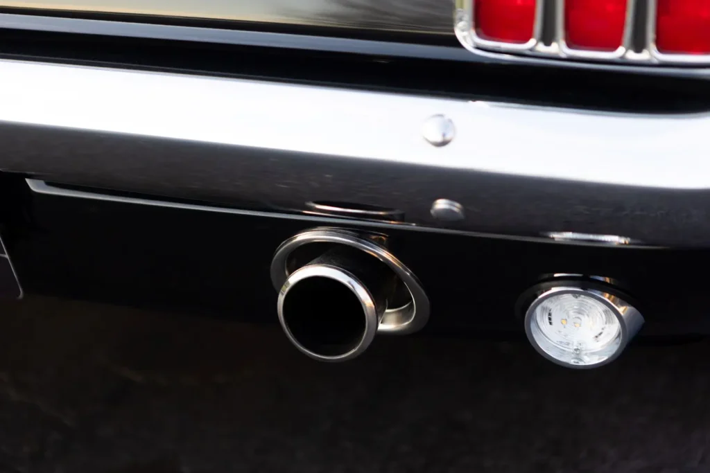 A close-up of a 1966 Mustang 2+2 Fastback exhaust pipe