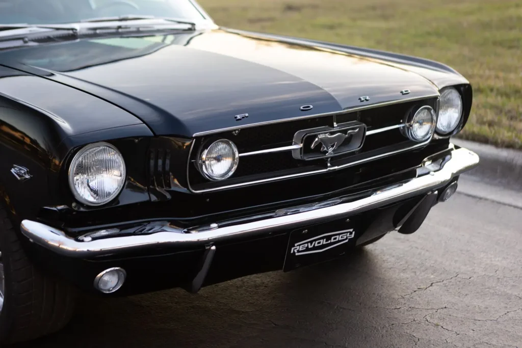 A front view of a 1966 Mustang 2+2 Fastback parked on the road