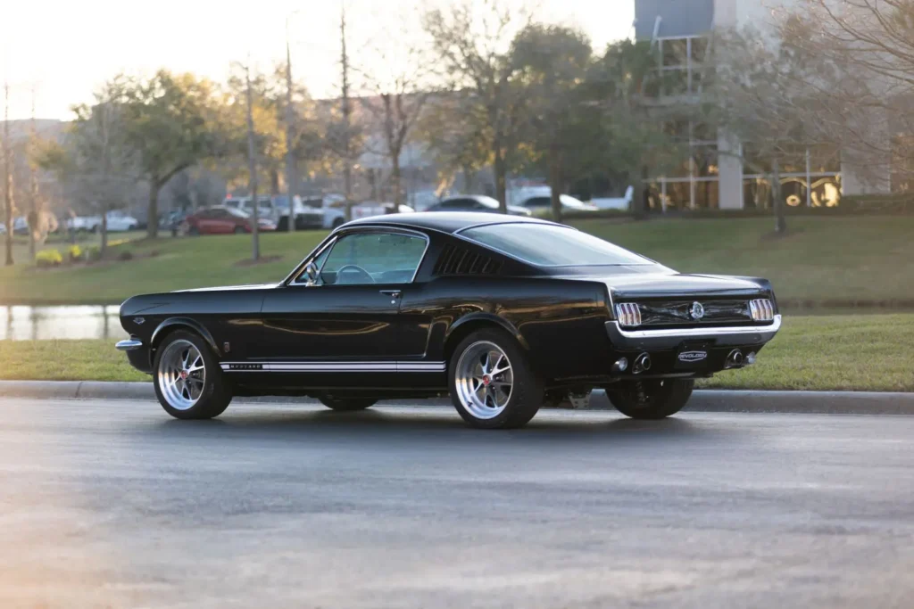 A wide shot back view of a 1966 Mustang 2+2 Fastback parked