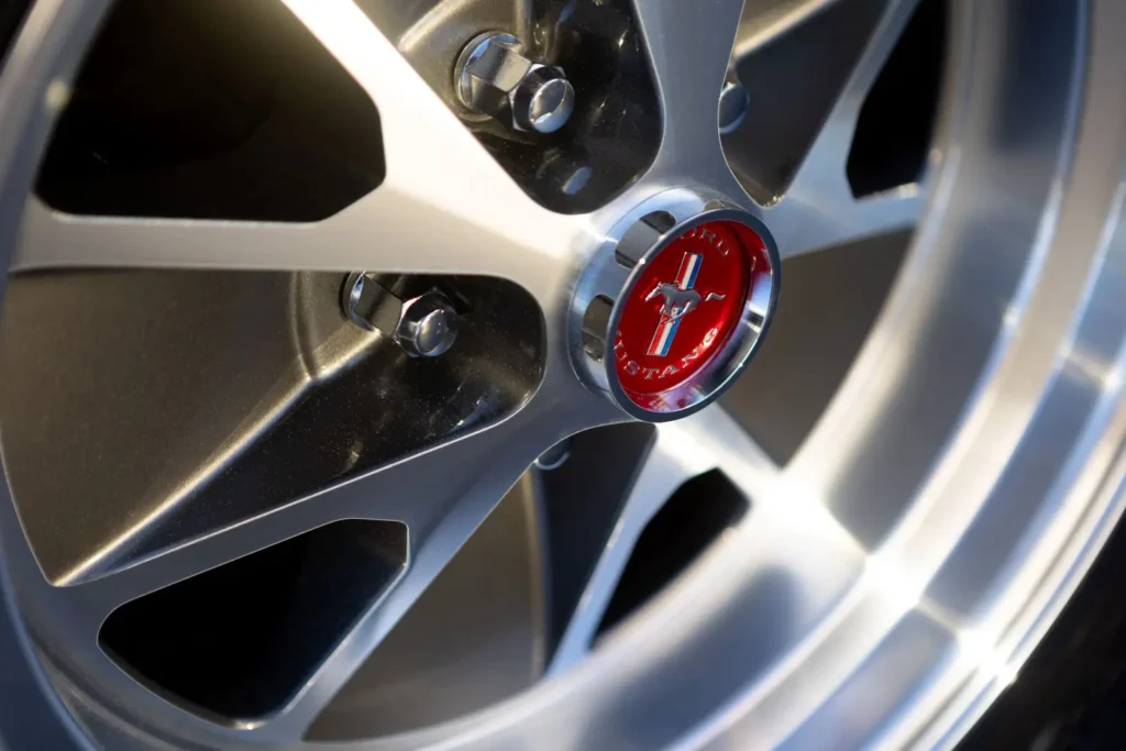 A wide wheel rim shot of a 1966 Mustang 2+2 Fastback logo