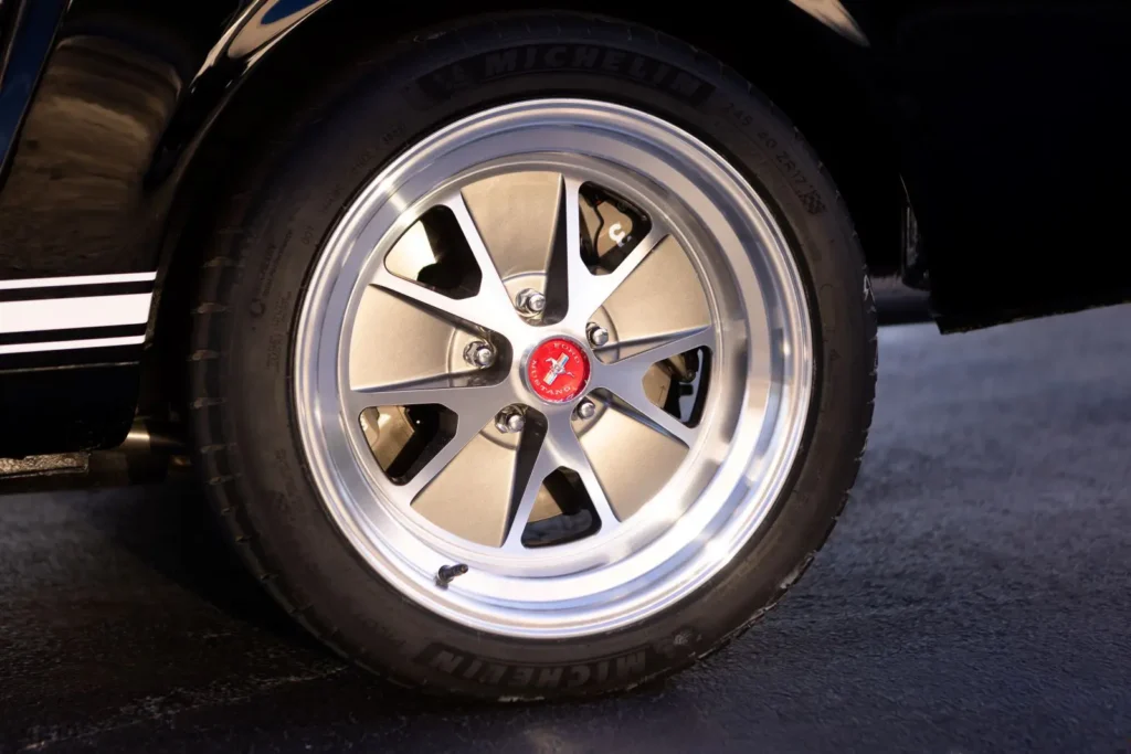 A wheel rim shot of a 1966 Mustang 2+2 Fastback logo