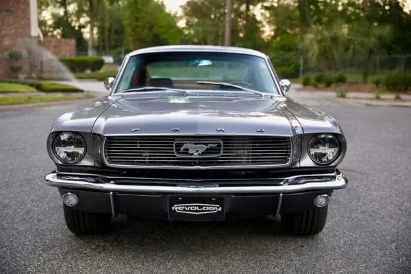 A front view of a 1966 Mustang 2+2 Fastback parked on the road