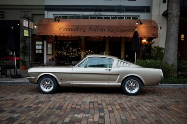 Steel unibody design of a 1966 Mustang 2+2 Fastback parked in a parking lot