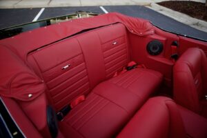 Backseat of a 1966 Mustang Convertible with a red interior.