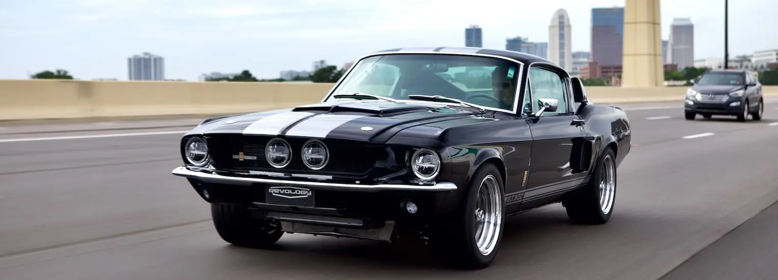 1967 Shelby GT500 classic car in black color with white stripes.