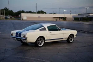 Back view of a white 1966 Shelby GT 350/ GT350H on a parking lot.