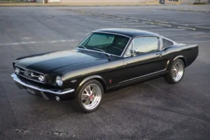 Black 1966 Mustang 2+2 Fastback parked in a parking lot.
