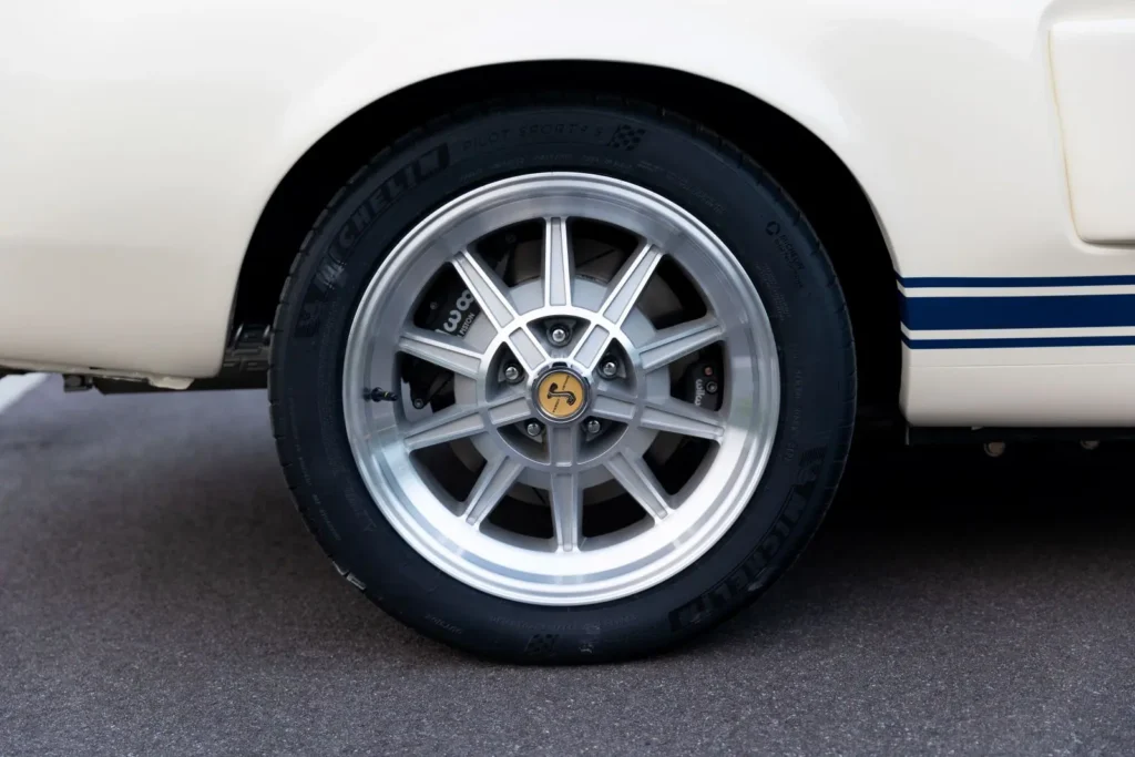 A close-up of a white 1967 Shelby GT 350 wheel rim.