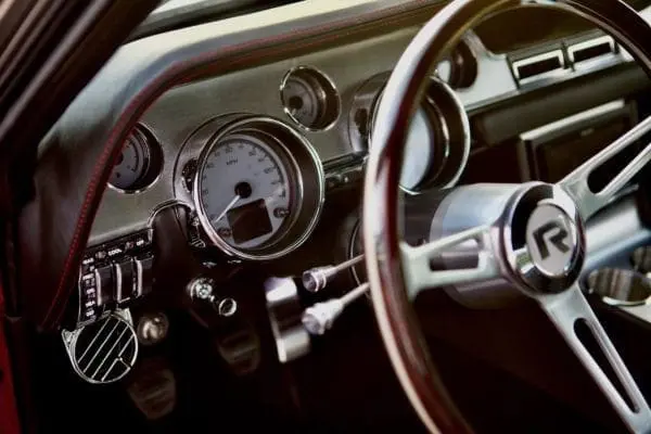 Close-up of a 1967 Shelby GT 350 dashboard and steering wheel.