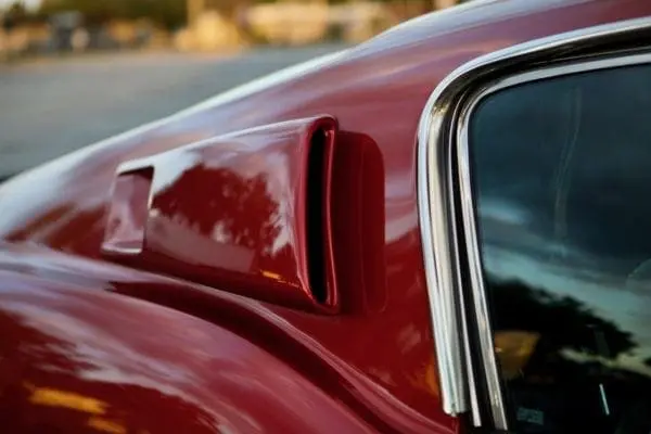 A close-up of a 1967 Shelby GT 350 upper side part fender vents.