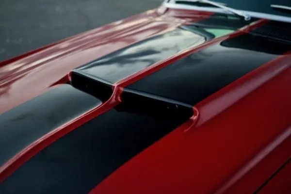 A red 1967 Shelby GT 350 hood fender vents exterior.