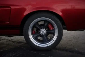 Back left tire of a red 1967 Shelby GT 350.