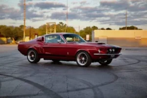Back view of a red 1967 Shelby GT 350 on a parking lot.