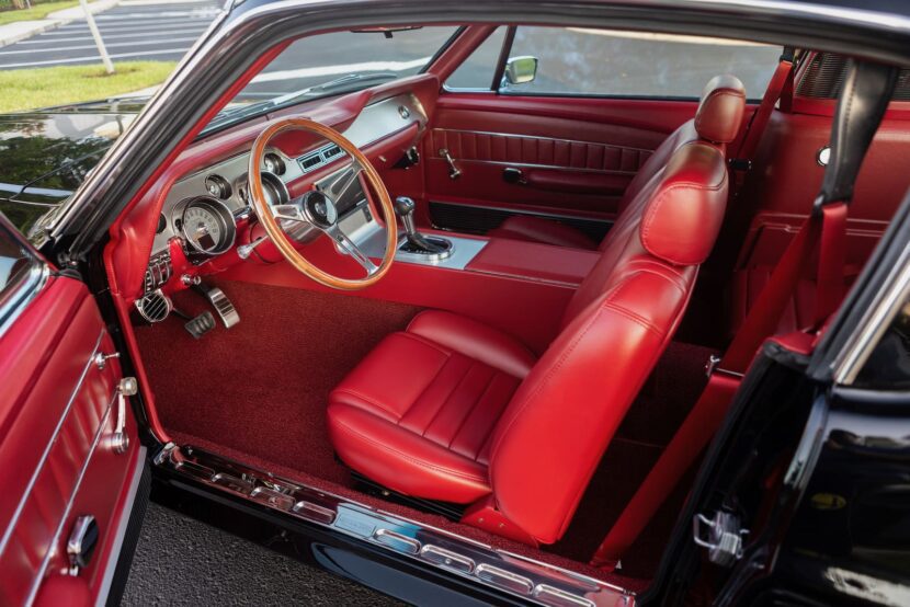 Red interior of a 1967 Mustang GT / GTA 2+2 Fastback with a left door open.