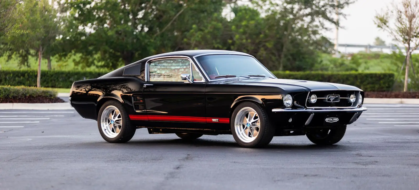 A rare view of a black 1967 Mustang GT / GTA 2+2 Fastback with red stripes.