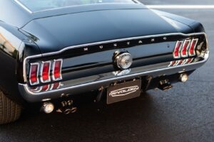A close-up of a black 1967 Mustang GT / GTA 2+2 Fastback trunk.