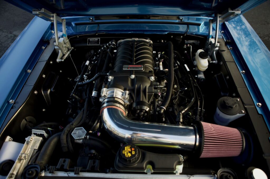 Open hood front view of a 1968 Mustang GT 2+2 Fastback Cobra Jet engine.