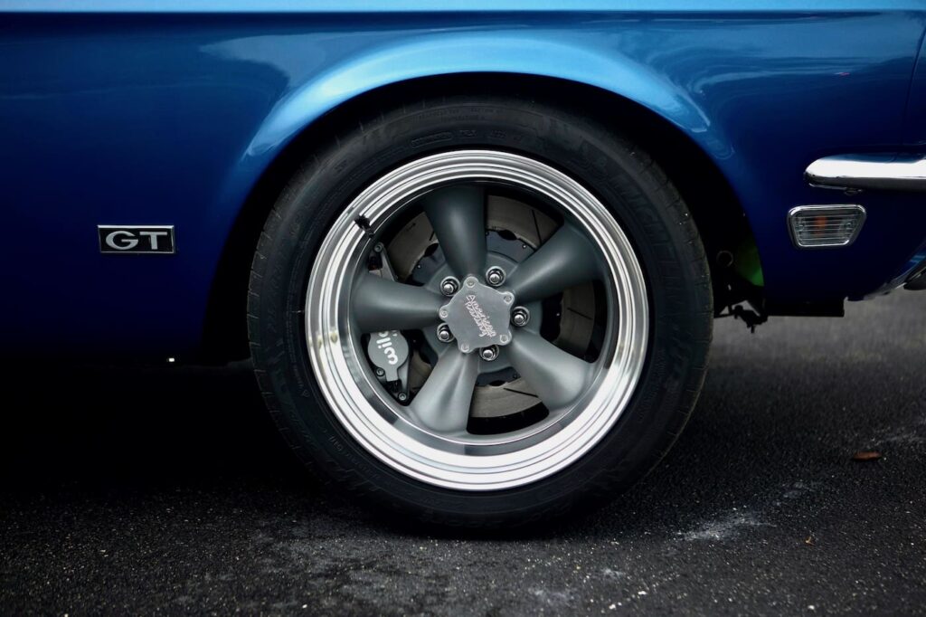 Back left tire of a black 1968 Mustang GT 2+2 Fastback Cobra Jet.