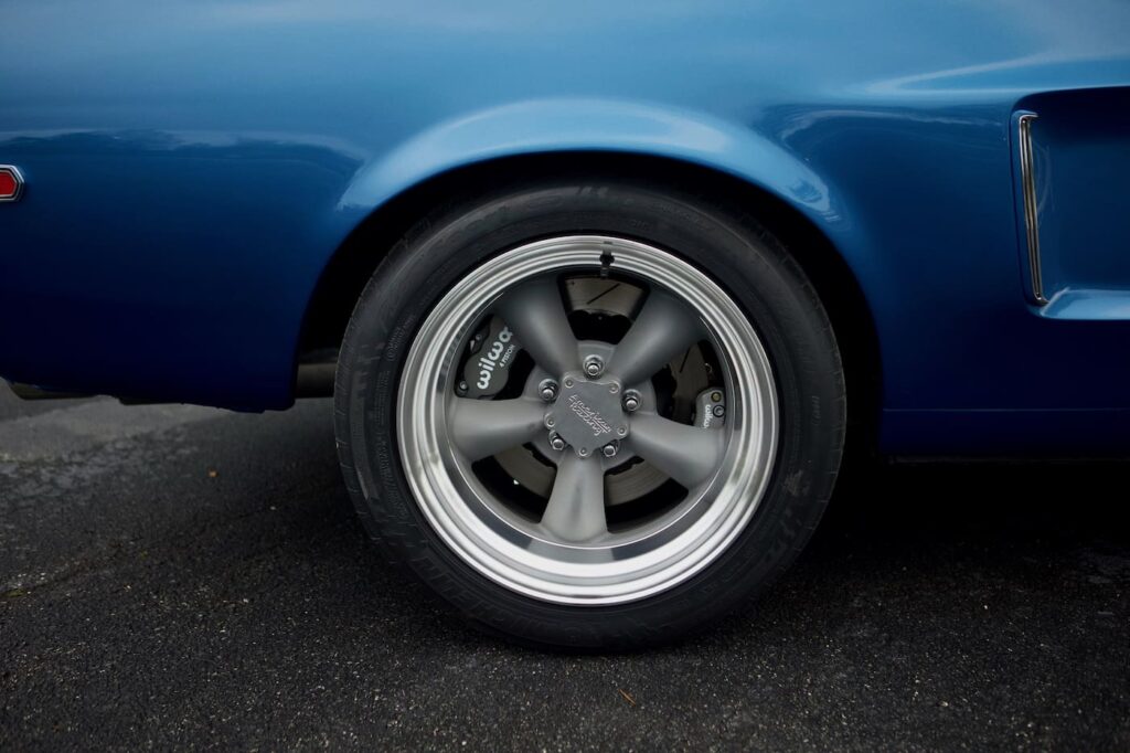 Back right tire of a blue 1968 Mustang GT 2+2 Fastback Cobra Jet.