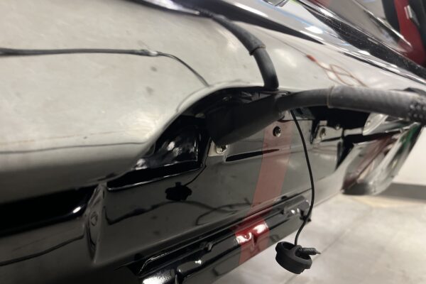 Charging system under the 66 Mustang Convertible rear bumper.