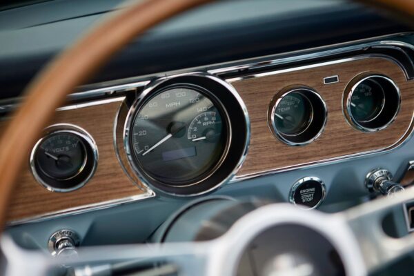 A dashboard of a vintage 1966 Mustang Convertible.