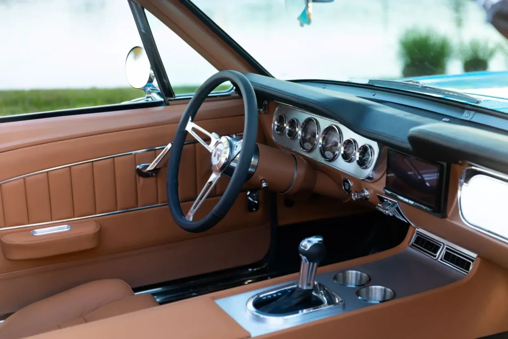 Close up shot of a 1966 Mustang Convertible brown interior and dashboard.