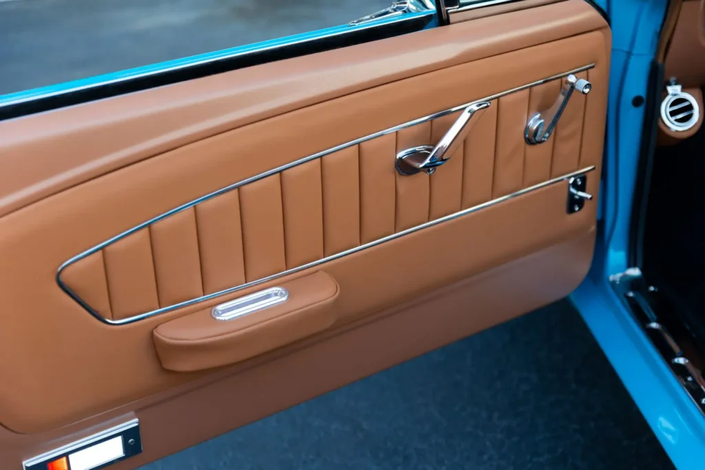 Closer look of a 1966 Mustang Convertible door leather brown interior.