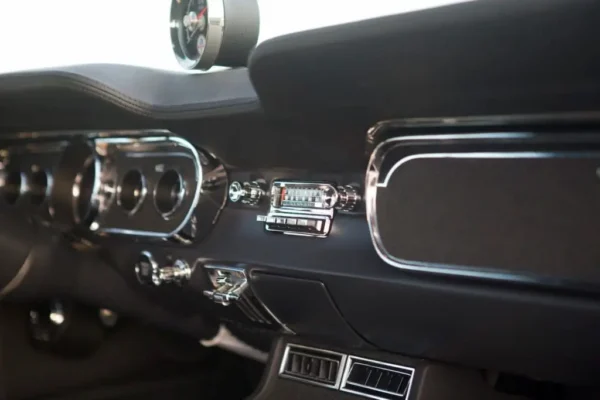 A close-up of a retro radio in a vintage 1966 Shelby GT 350/ GT 350H