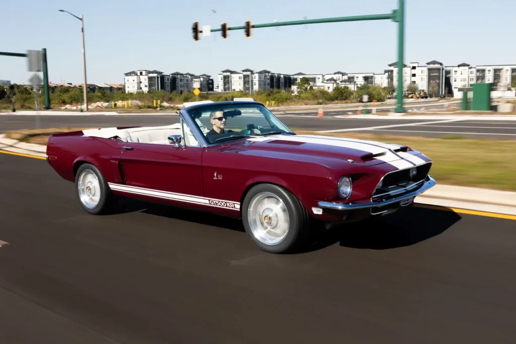 Driver driving 1968 Shelby GT500 KR Convertible in motion on road