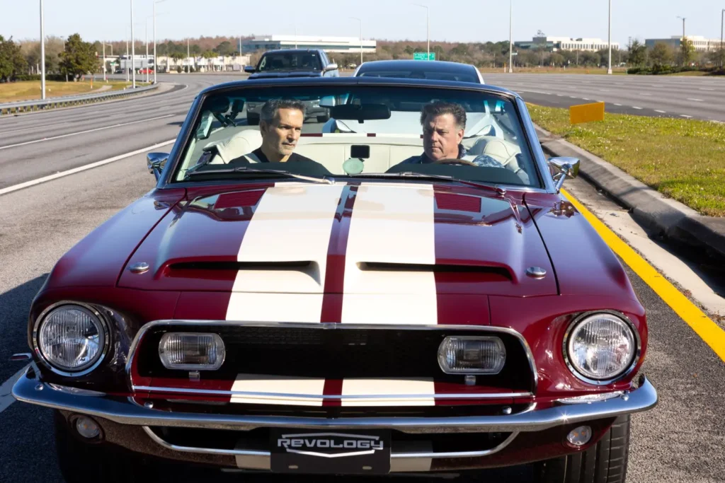 Two men driving in 1968 Shelby GT500 KR Convertible