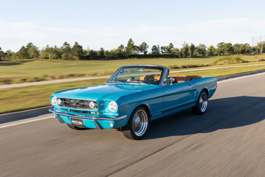 A shot of in motion 1966 Mustang Convertible on a road