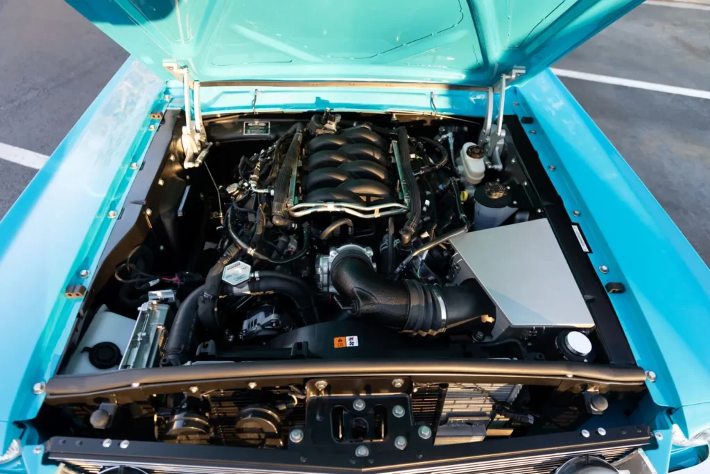 Baby blue 1966 Mustang Convertible open hood close engine view.