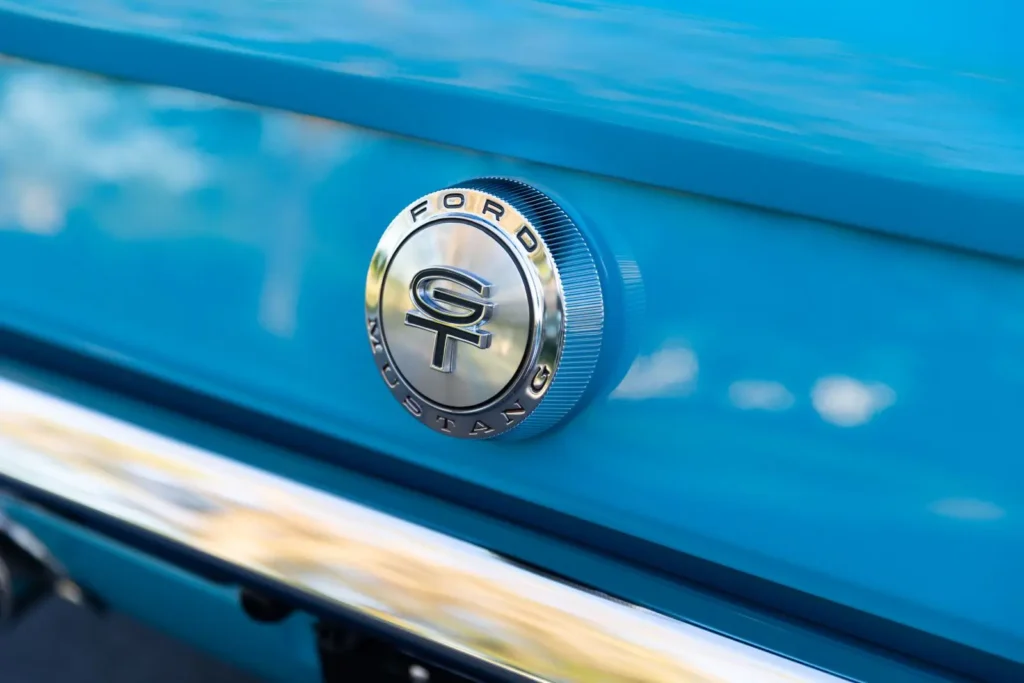 A close-up look of a blue 1966 Mustang Convertible emblem