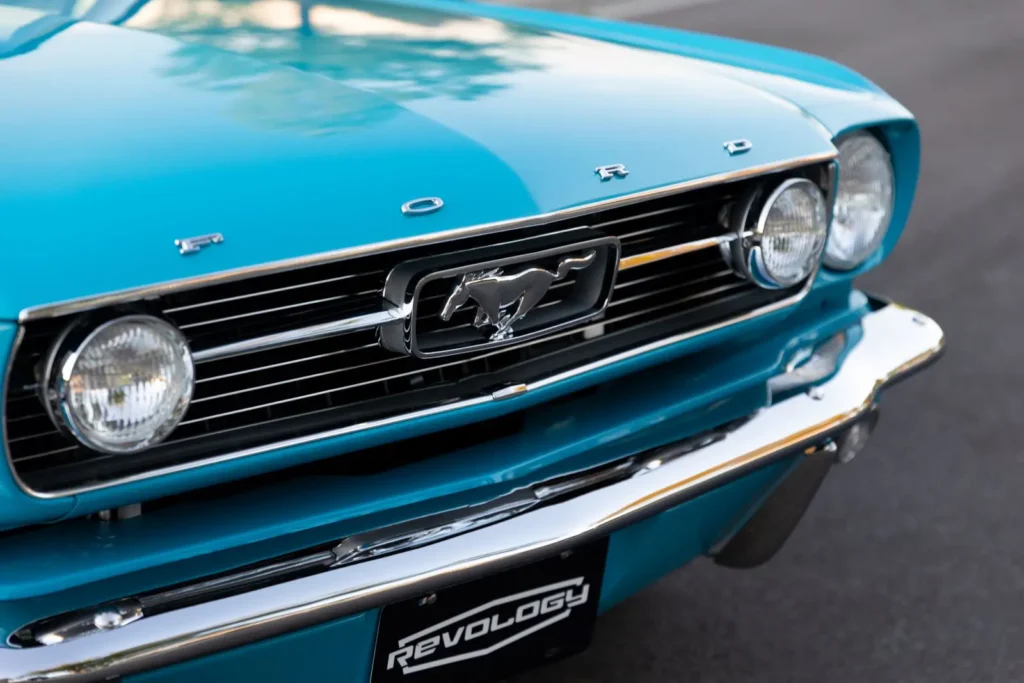 A front close up view of a blue 1966 Mustang Convertible.