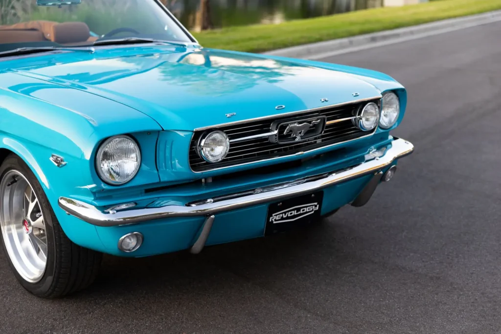 A front view of a parked blue 1966 Mustang Convertible.