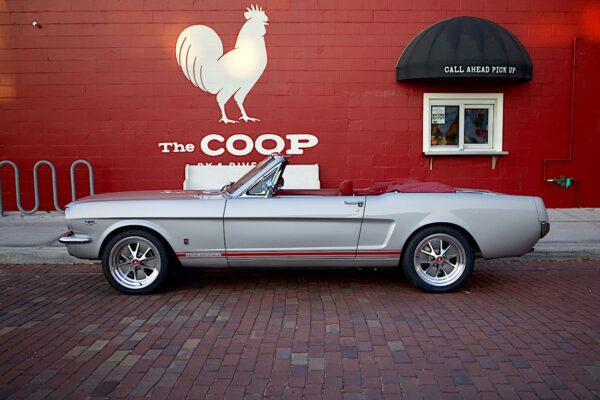 Grey 1966 Mustang Convertible parked in front of “The Coop”.
