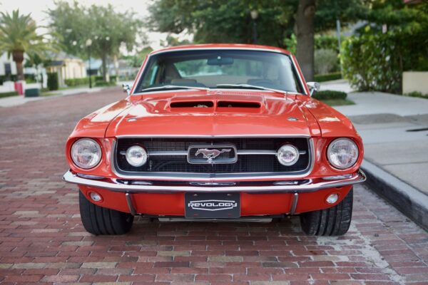 The front view of a red 1967 Mustang GT / GTA 2+2 Fastback.