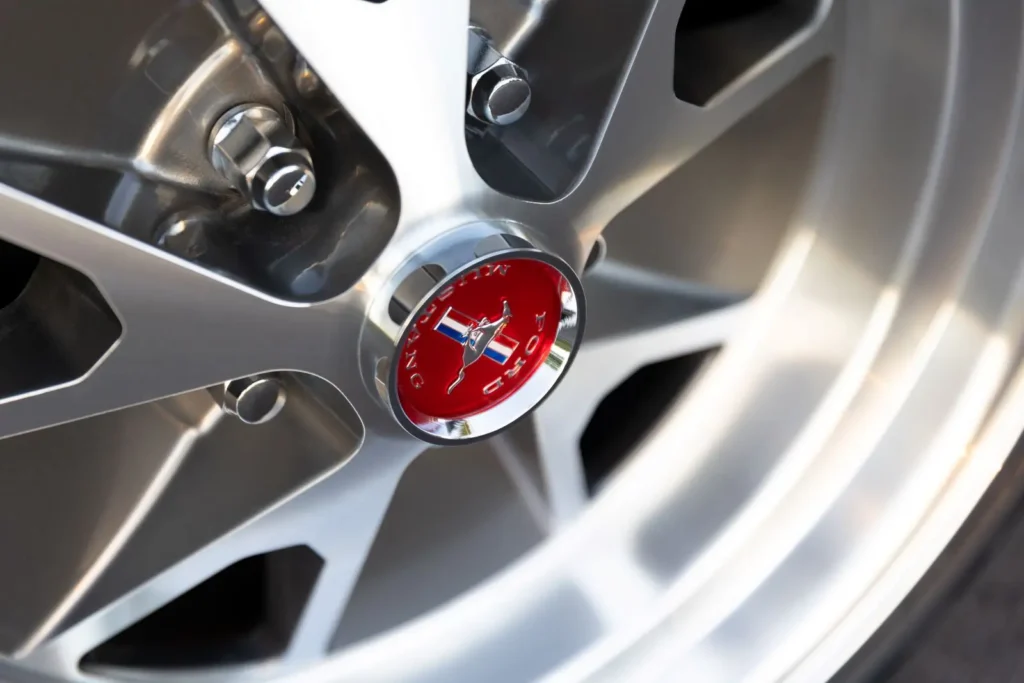 A close-up of a 1966 Mustang Convertible wheel rim emblem