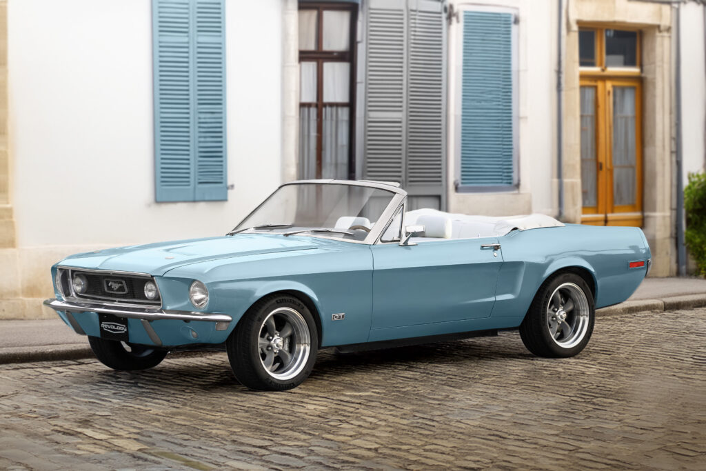 1968 Mustang GT Convertible in blue on cobblestone street.