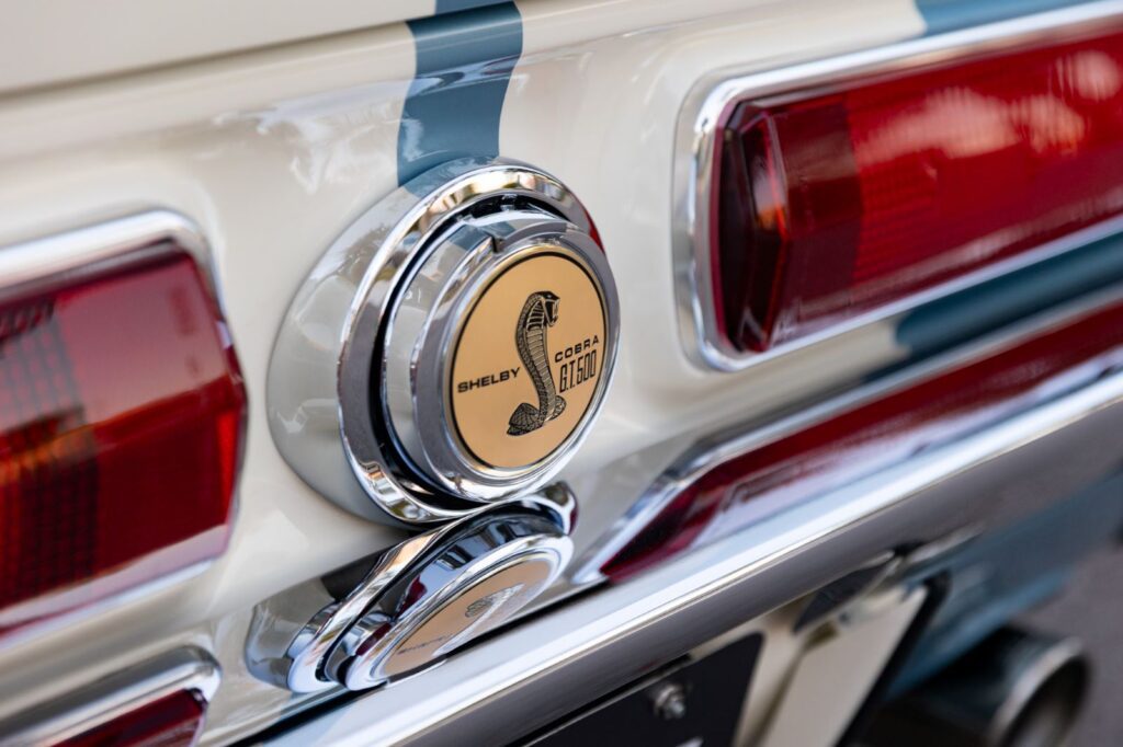 Close-up of the chrome Shelby Cobra flip-top gas cap and horizontal rear taillights on a 1967 Revology Shelby GT500 Fastback.